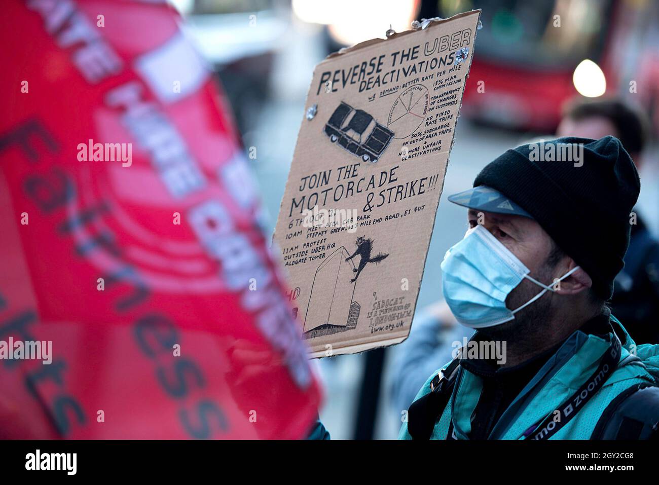 London, UK. 06th Oct, 2021. Uber driver seen holding placard at 