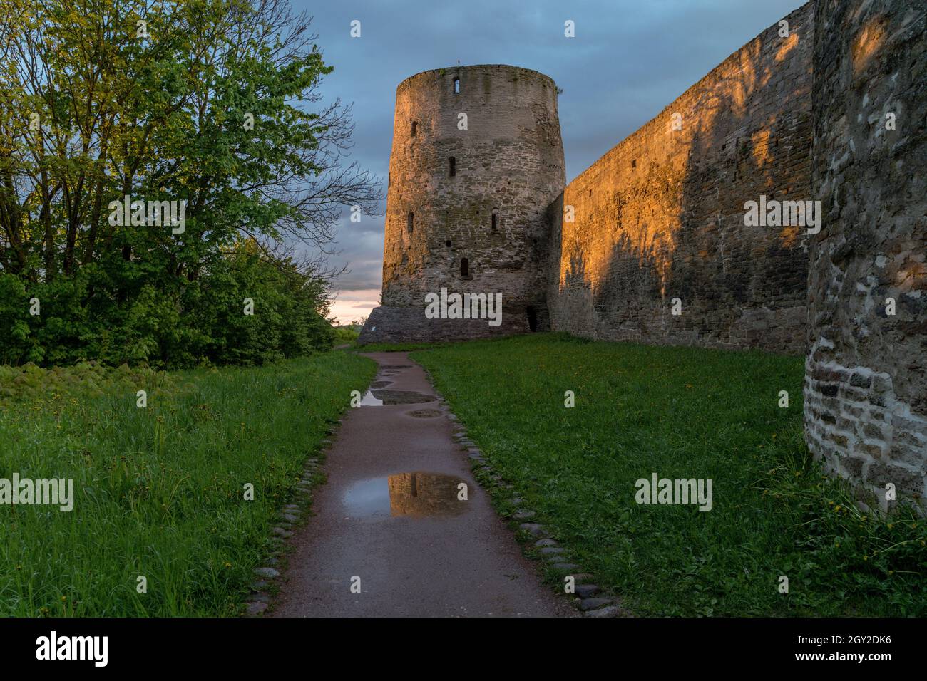 Landscape at sunset. The medieval wall of the Izborsk fortress. Pskov Region, Russia Stock Photo