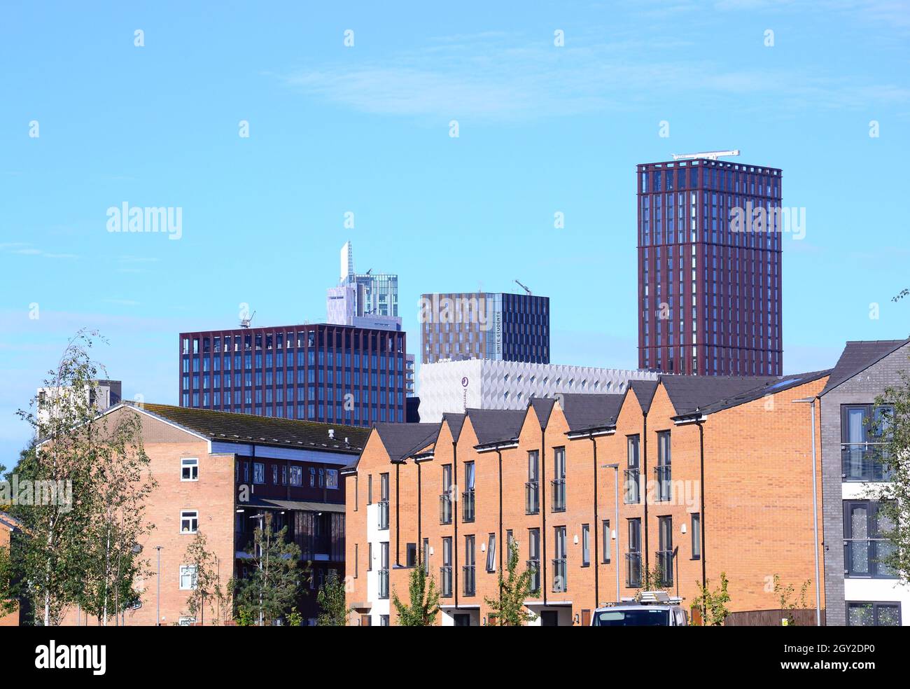 Skyscrapers or high rise buildings, with new houses in foreground, in central Manchester, England, United Kingdom, seen from the South of the city. Stock Photo