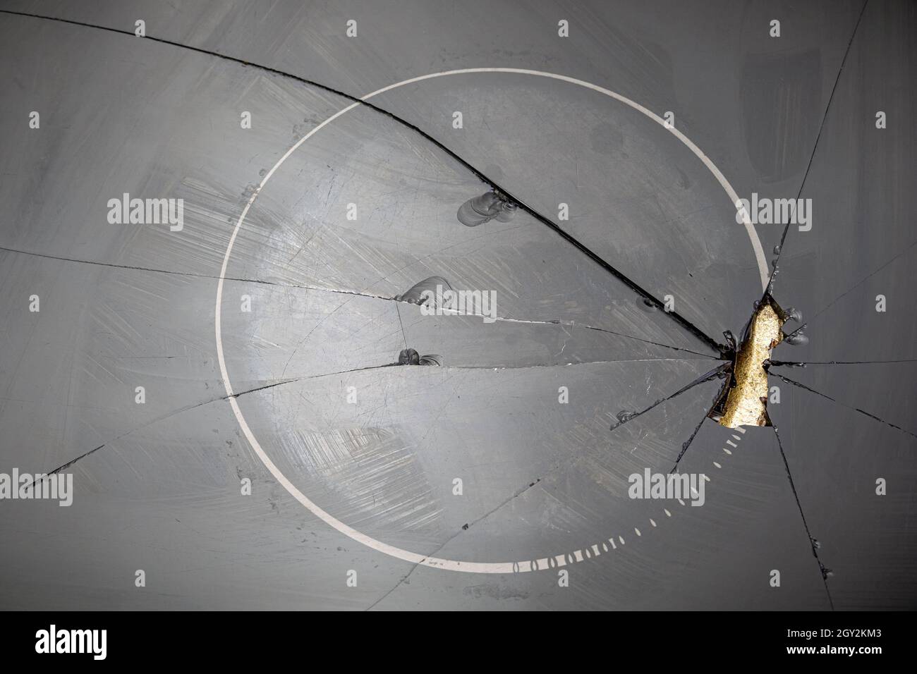 Broken ceramic glass cooktop with hole and cracks closeup Stock Photo