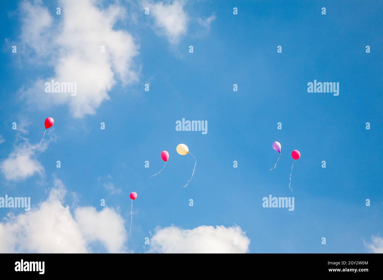 Six party balloons floating away in the sky. 2008 Stock Photo