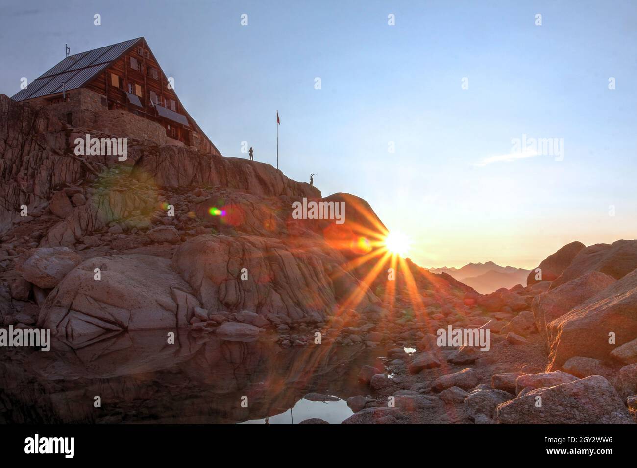 First rays of sunrise at Cabane d'Orny, located at 2826m altitude in the Swiss part of Mont Blanc Massif, on the edge of Glacier d'Orny. Stock Photo