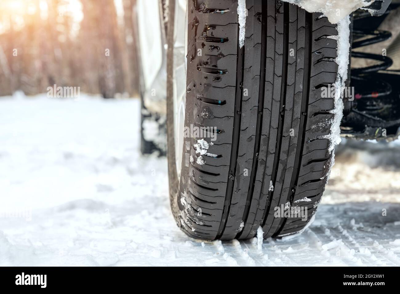 Closeup detail view of car wheel with unsafe summer tread tire during