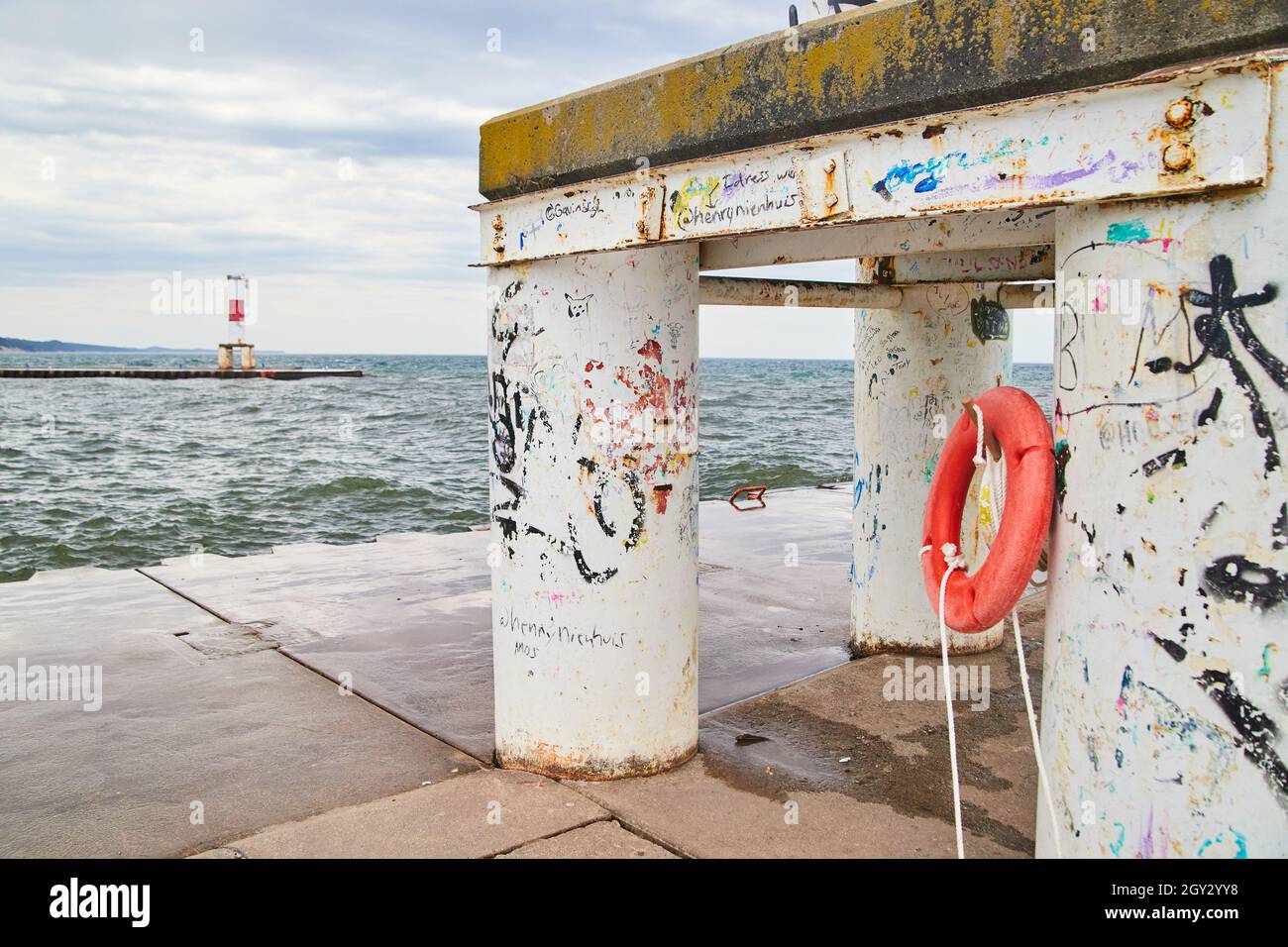 Close up of structure on pier with peeling paint and lake view Stock Photo