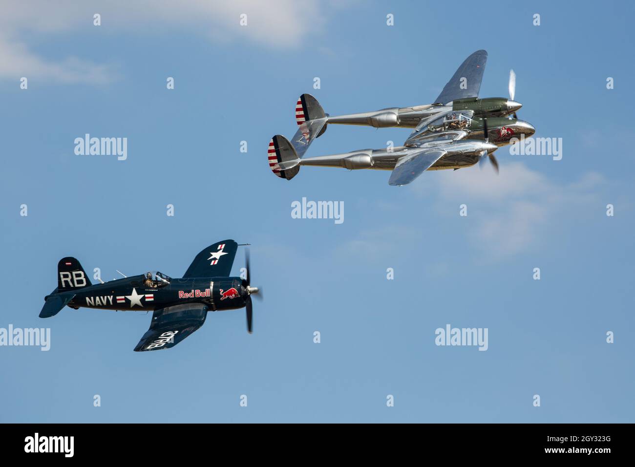 Red Bull Lockheed P38 Lightning and Vought FG1d Corsair Vintage WW2 Fighter at Flying Legends Duxford Airshow Stock Photo