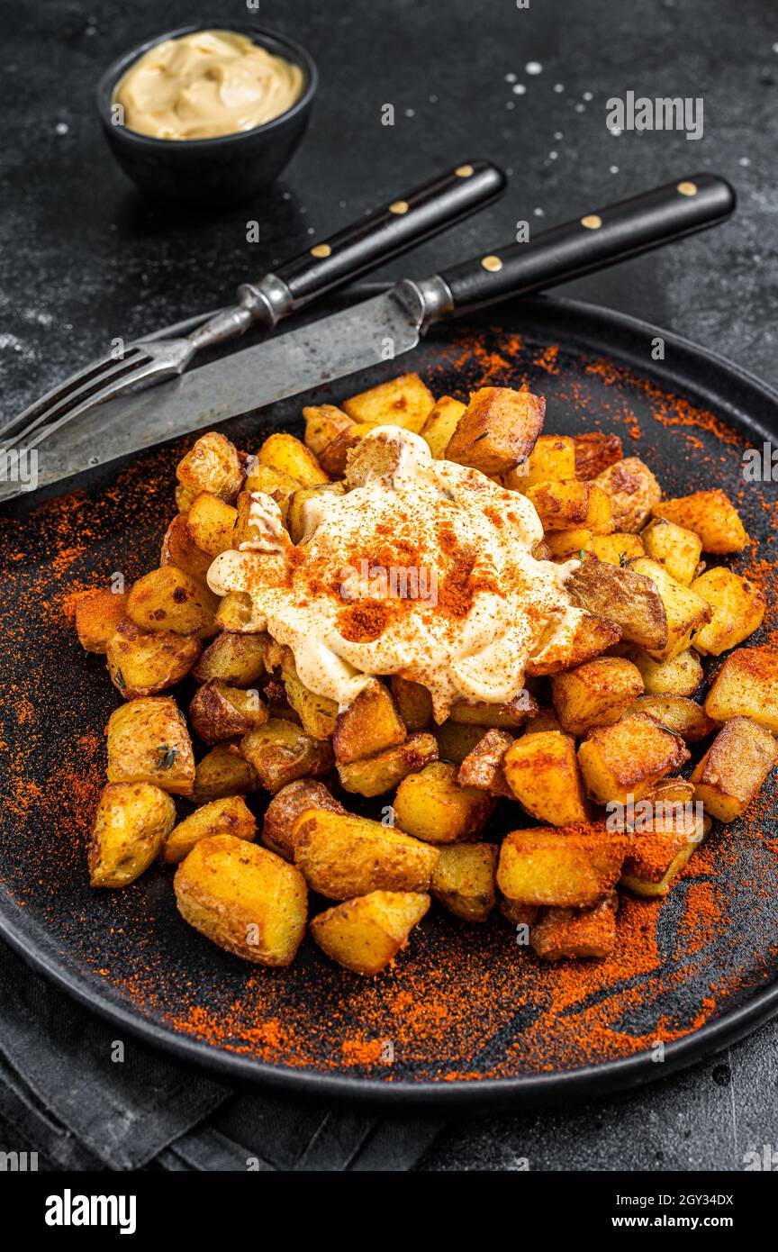 Patatas Bravas, traditional Spanish tapas, baked potato with spicy