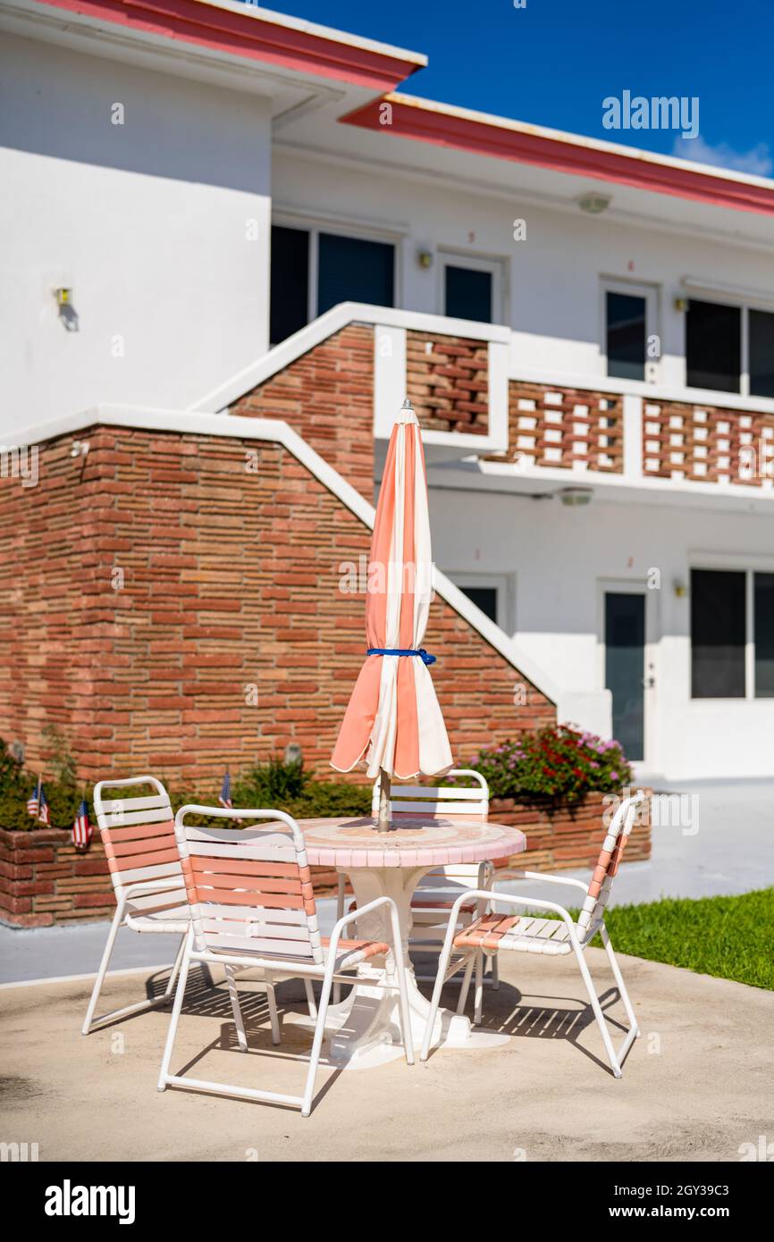 Vintage Florida concrete beach table with umbrella and chairs Stock