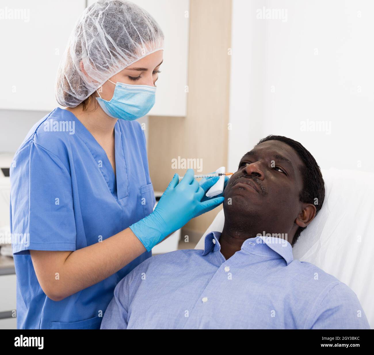 Man getting procedure of injection for face skin tightening Stock Photo