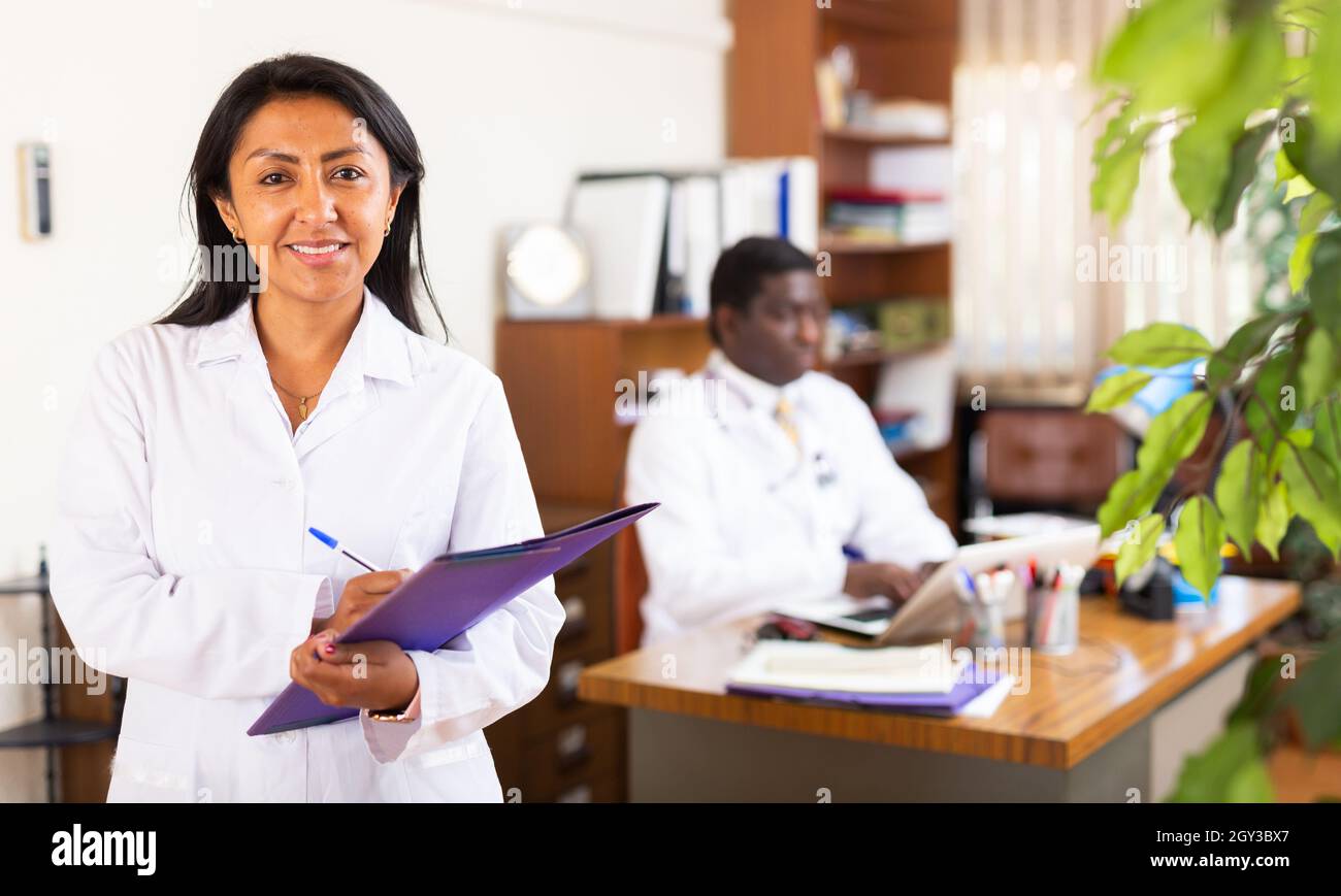 Woman doctor wear white medical uniform and stethoscope with folder of ...