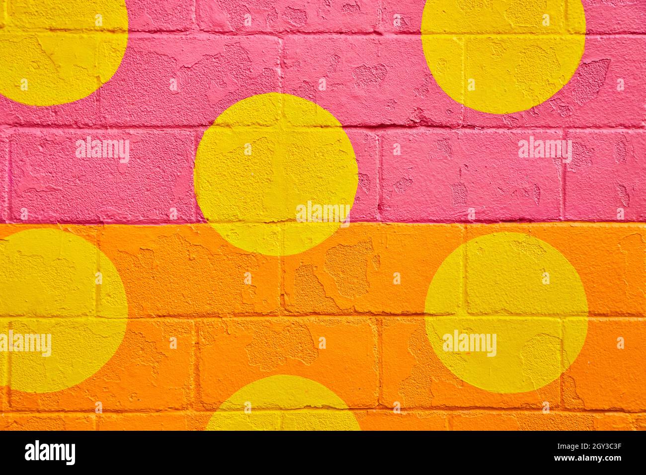 Cement block texture painted with orange and pink and yellow spots Stock Photo