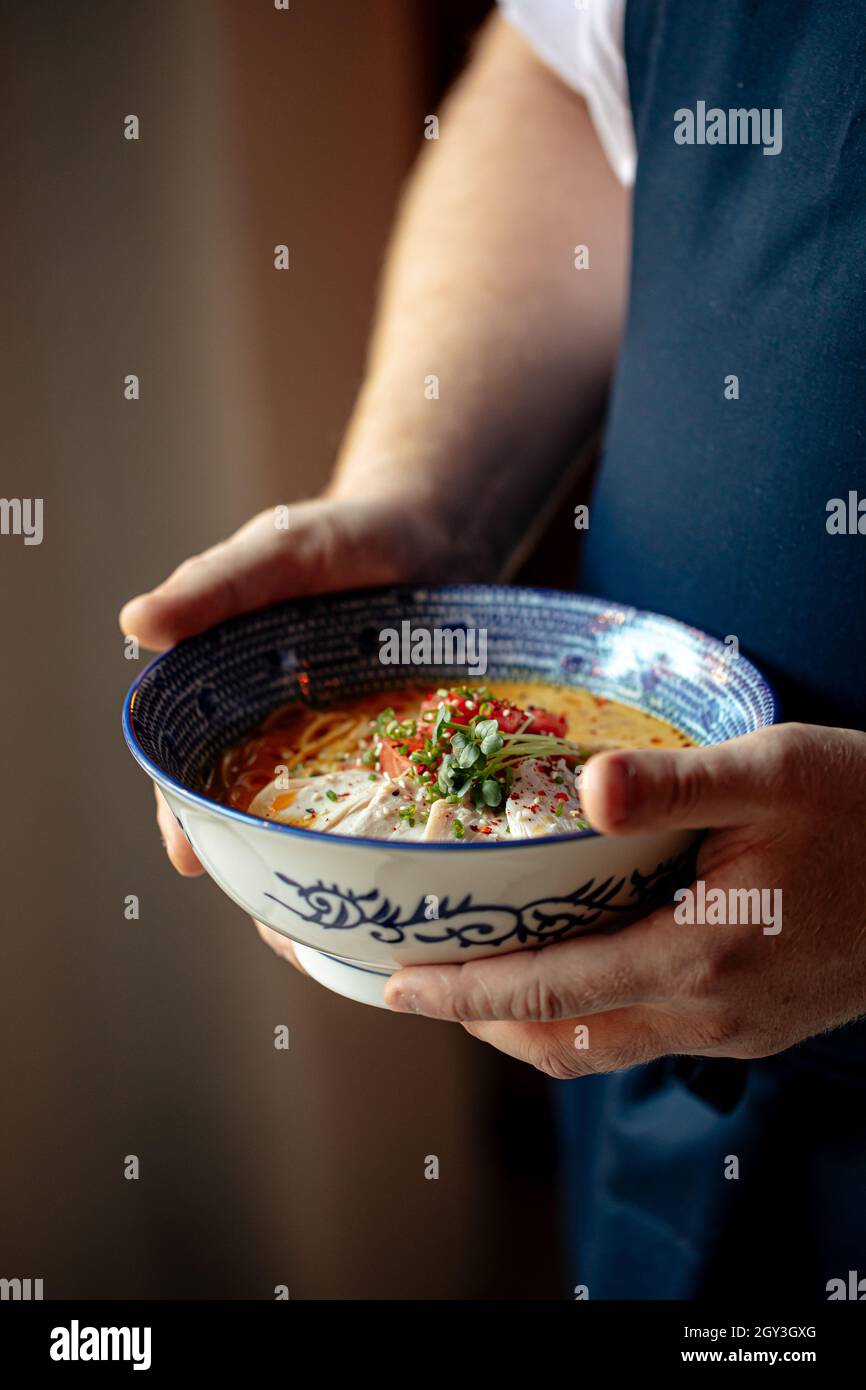 Chef holding bowl of japanese curry chicken ramen Stock Photo