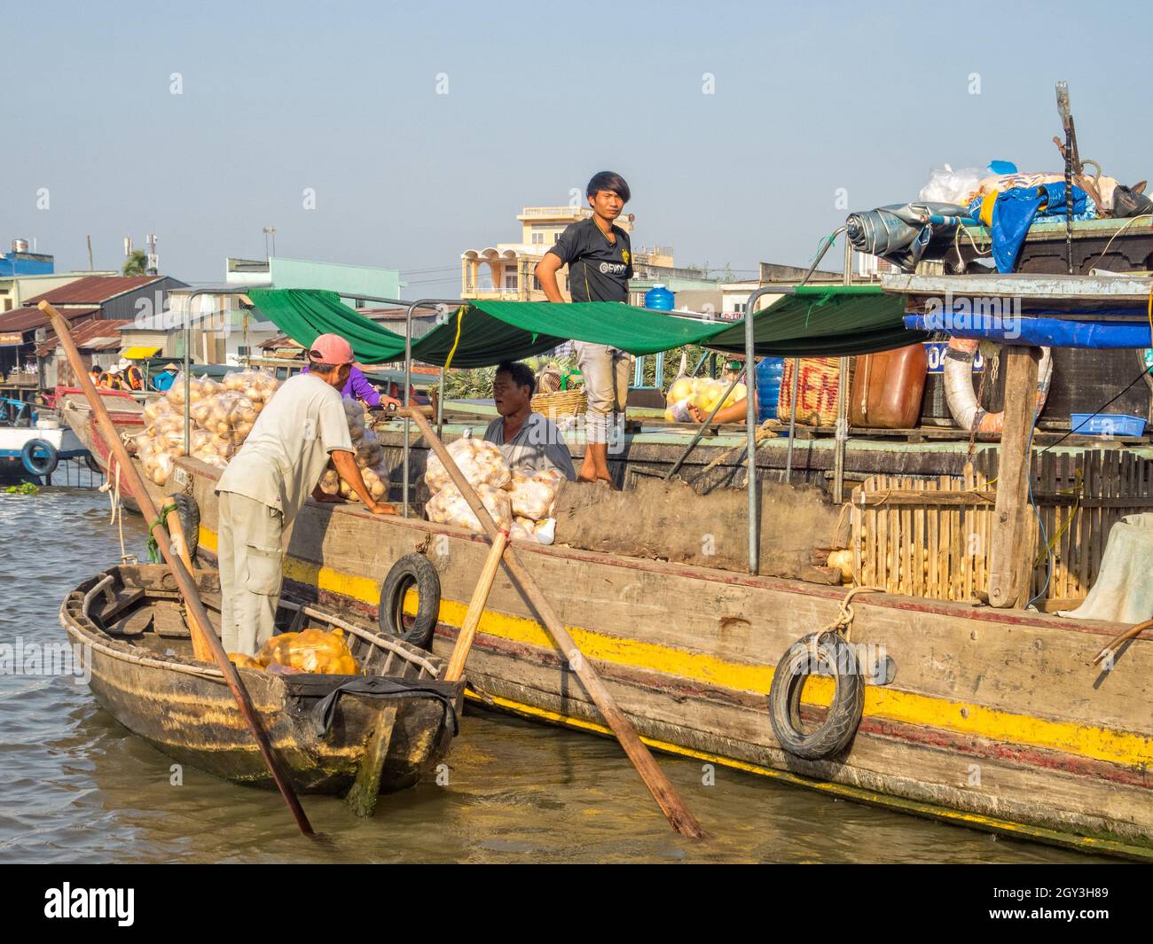 Locals are trading goods from their boats in the floating market on the ...