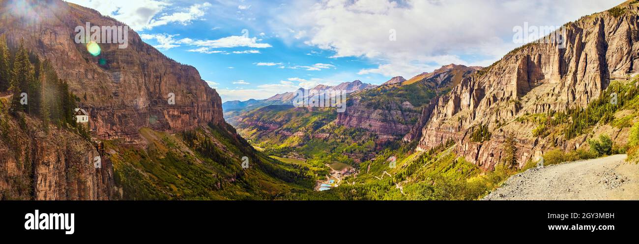 Panorama of vast valley in the mountains surrounded by vertical rocky cliffs Stock Photo