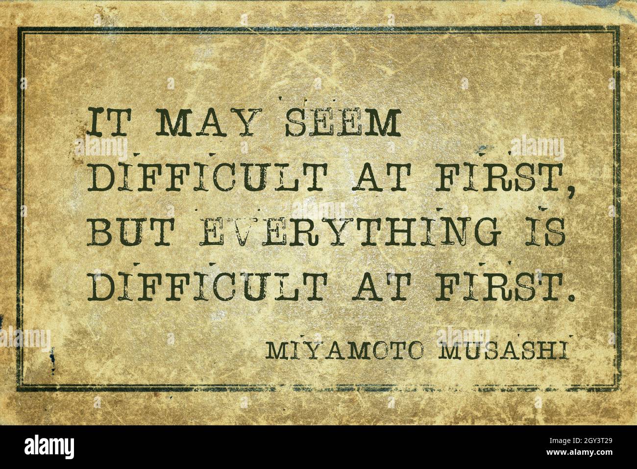 It may seem difficult at first, but everything is difficult at first - ancient Japanese swordsman and ronin Miyamoto Musashi quote printed on grunge v Stock Photo