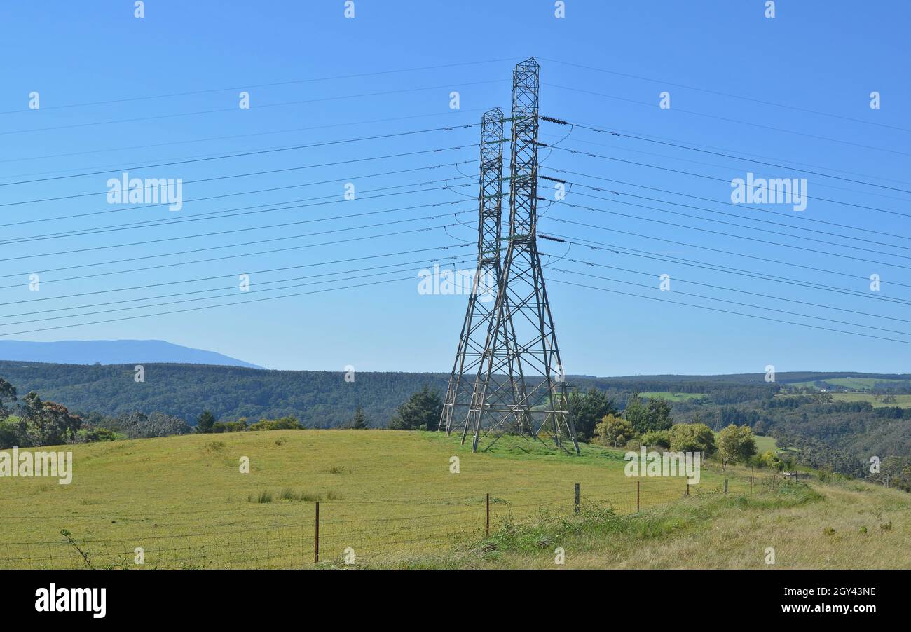 Powerlines or transmission line cross the countryside in eastern Victoria. Stock Photo