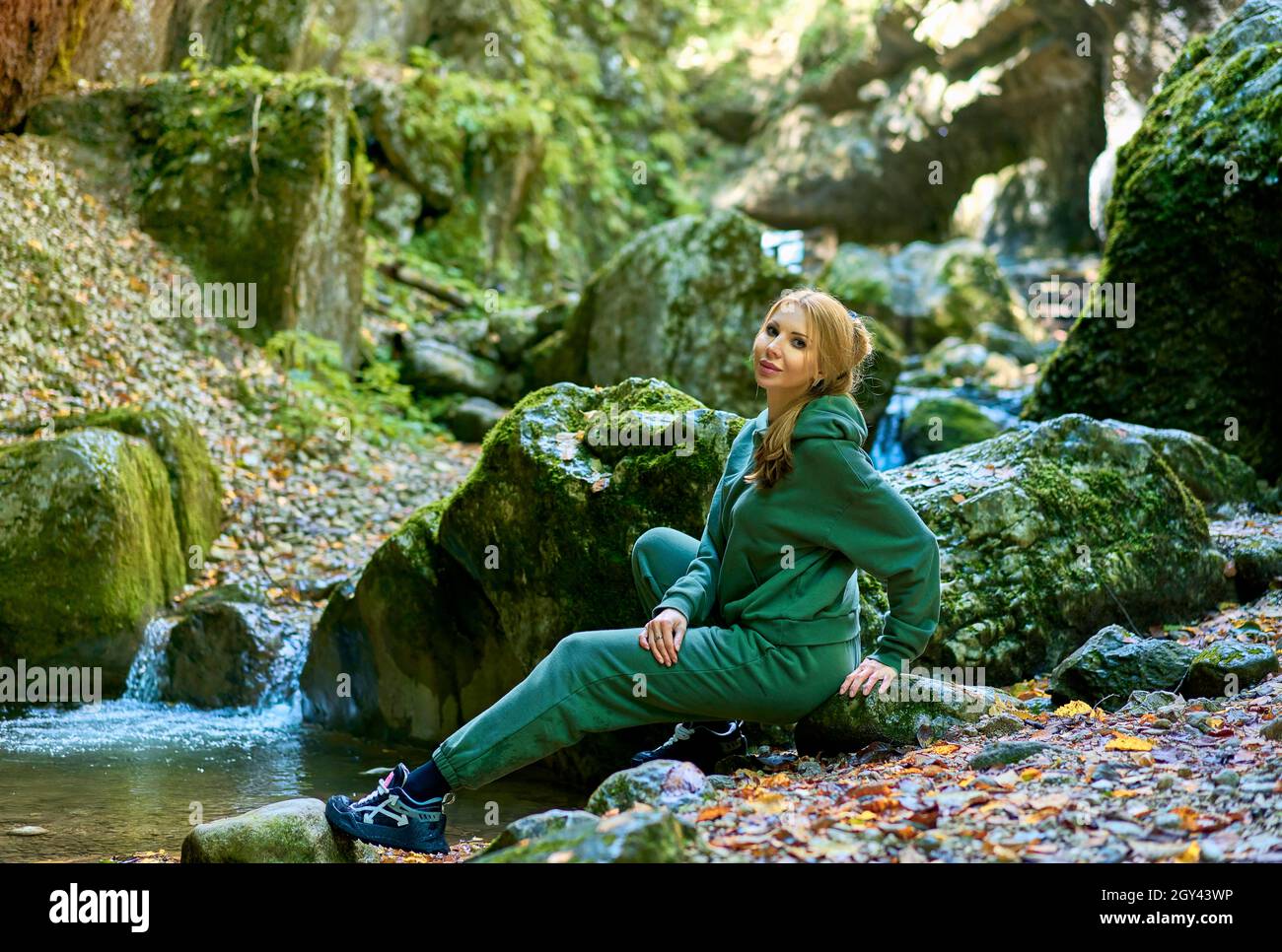 Woman hiking in autumn forest in mountains. Recreation and healthy ...