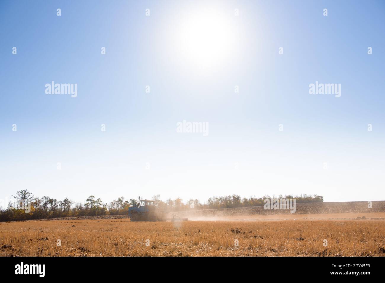 the tractor plows the field in autumn Stock Photo - Alamy