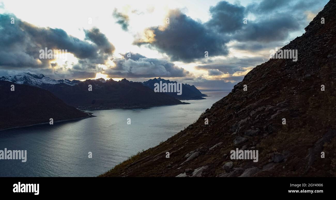 Sunset behind a snowy mountain range Stock Photo - Alamy