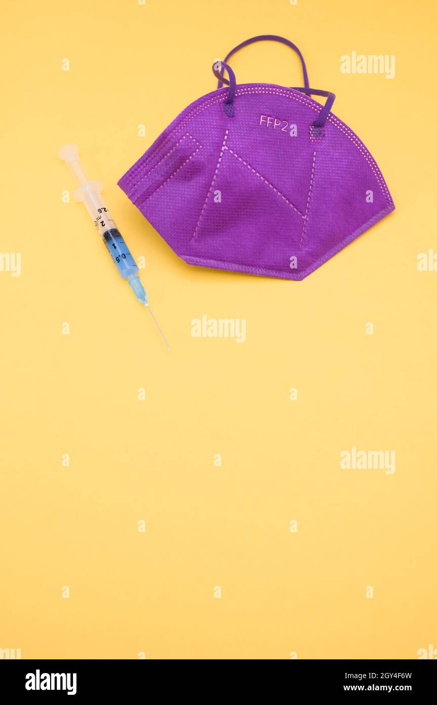 Isolated respiratory mask and syringe on a yellow background Stock ...