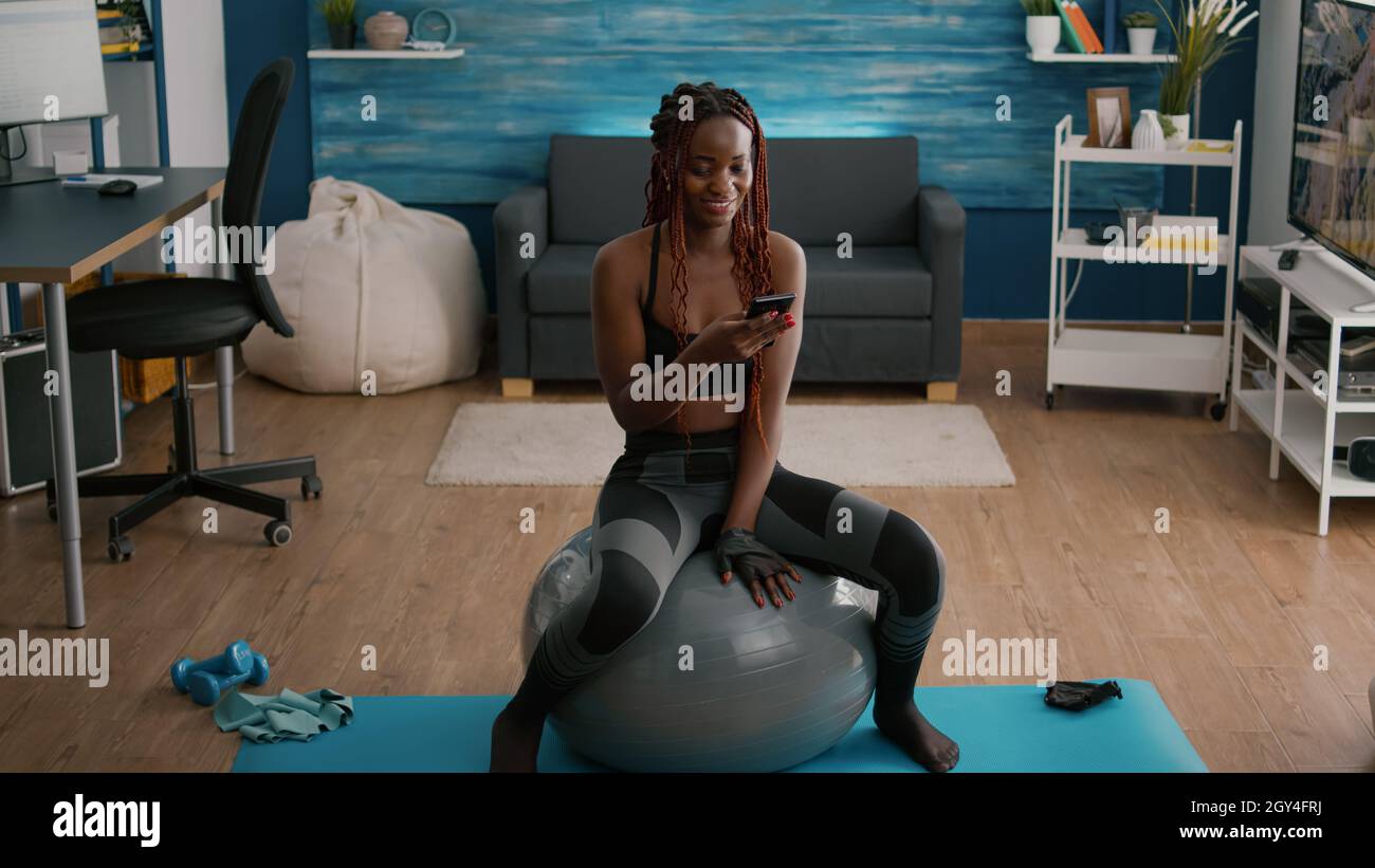 Slim Fit Black Woman Sitting on Yoga Swiss Ball Doing Abs Exercise, Stock  Footage