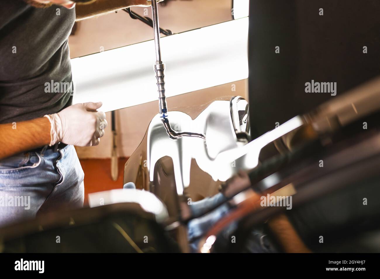 Mechanic doing car maintenance hi-res stock photography and images - Alamy