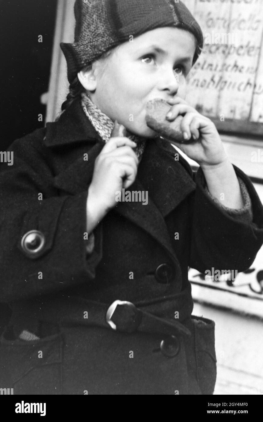 Kind an einer Wurstbude in Breslau, Niederschlesien; Deutsches Reich 1930er Jahre. Child at a snack bar in Breslau, Lower Silesia, Germany 1930s. Stock Photo