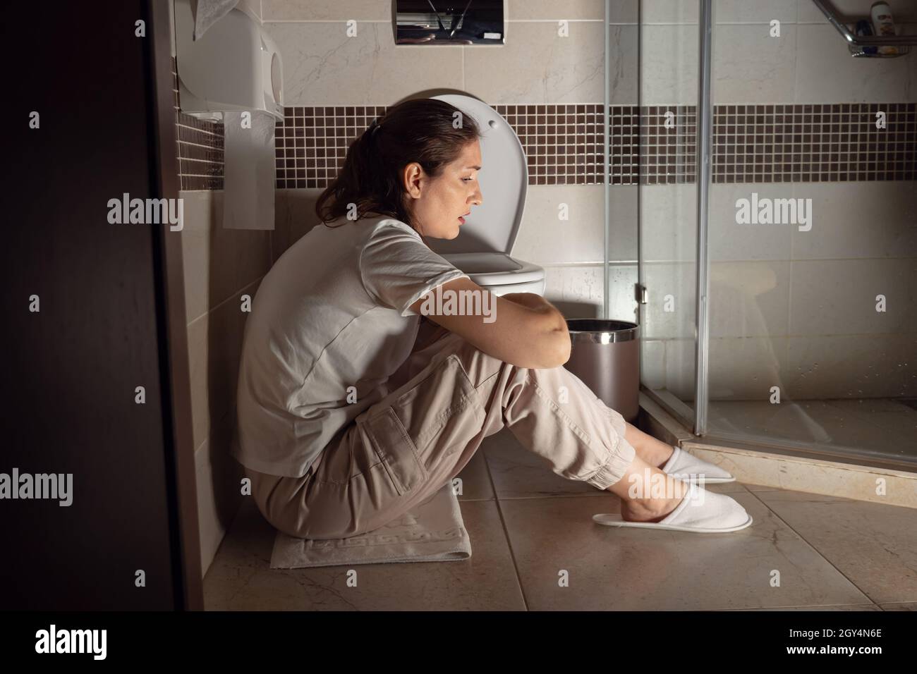 Woman sitting in bathroom hi-res stock photography and images - Alamy
