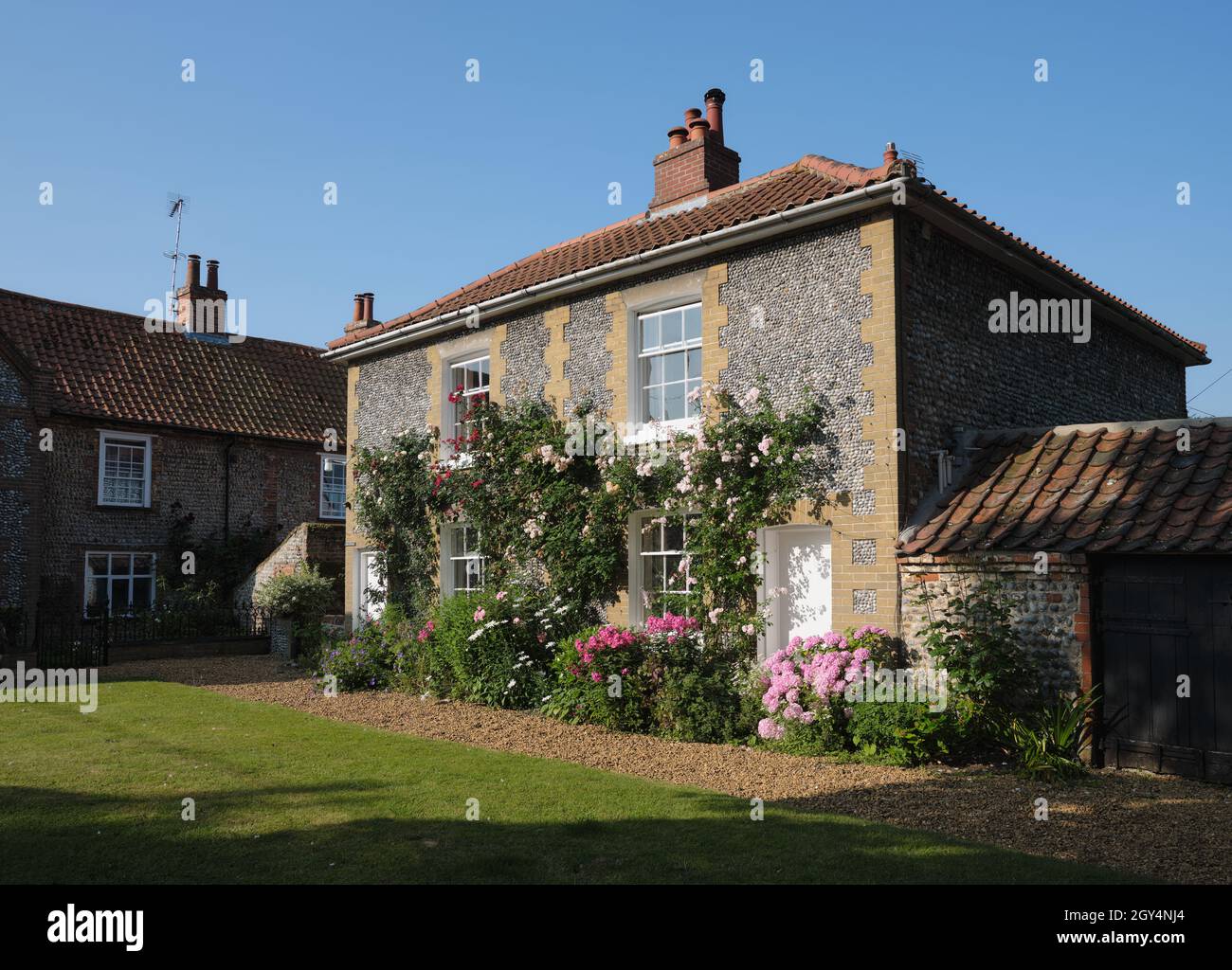 Typical flint stone Norfolk cottage house architecture in Cley Next To