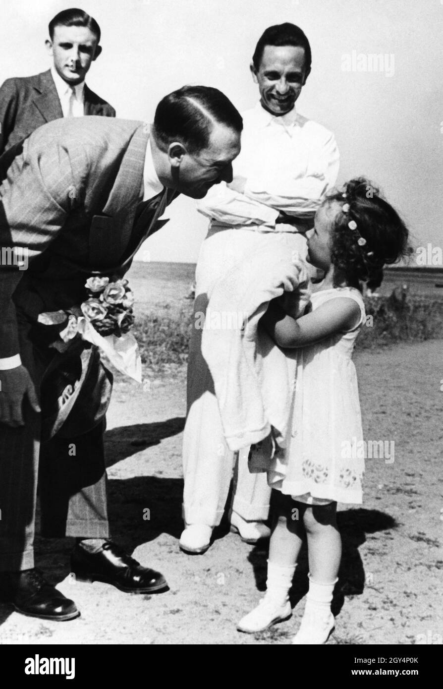 Adolf Hitler greets, in the presence of her father Joseph, Helga Goebbels, the eldest of six children of the Goebbels couple. Peter Longerich, the Hitler and Goebbels biographer described the Gooebbels as Hitler's surrogate family. Hitler was called Uncle Adolf by the children and Magda Goebbels chose to poison the children after the end of the Third Reich was certain and Hitler also took his own life. [automated translation] Stock Photo