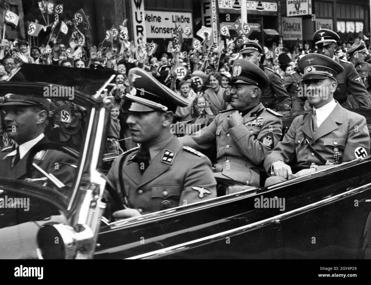 Adolf Hitler and Benito Mussolini are driven through Munich in a Mercedes W150 by Erich Kempka. [automated translation] Stock Photo