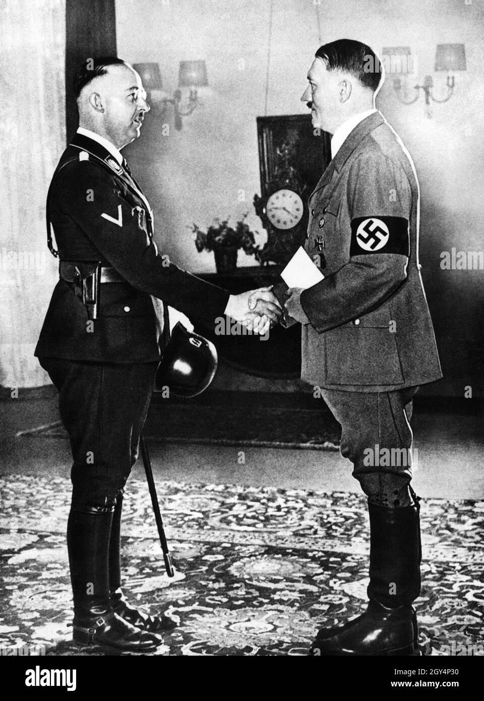 In June 1936, Hitler appointed Reichsführer SS Heinrich Himmler as head of the German police. The SS, which Himmler had taken over in 1929 and which was then only 80 strong, had in the meantime become so interwoven with the police apparatus that it already formed a state within the state. With it Hitler created an instrument that could no longer be controlled by anyone except himself and Himmler. The Totenkopf units guarding the concentration camps later became the core of the Waffen-SS. The police, especially the GESTAPO and de SD, filled their higher leadership positions almost exclusively Stock Photo