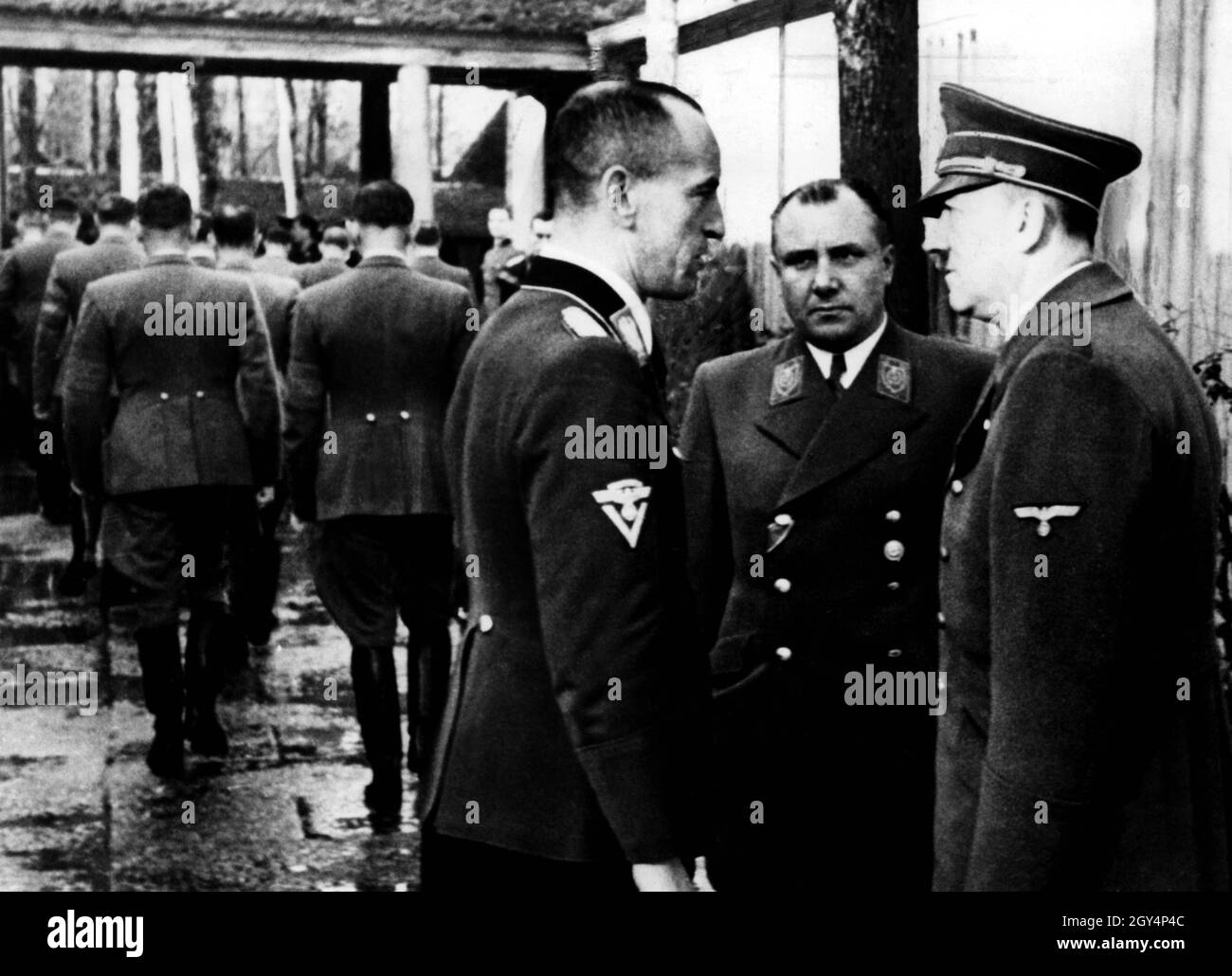 Adolf Hitler in conversation with Martin Bormann and NSKK (National Socialist Motor Vehicle Corps) leader Erwin Kraus at Führer Headquarters during the visit of the party leadership. [automated translation] Stock Photo