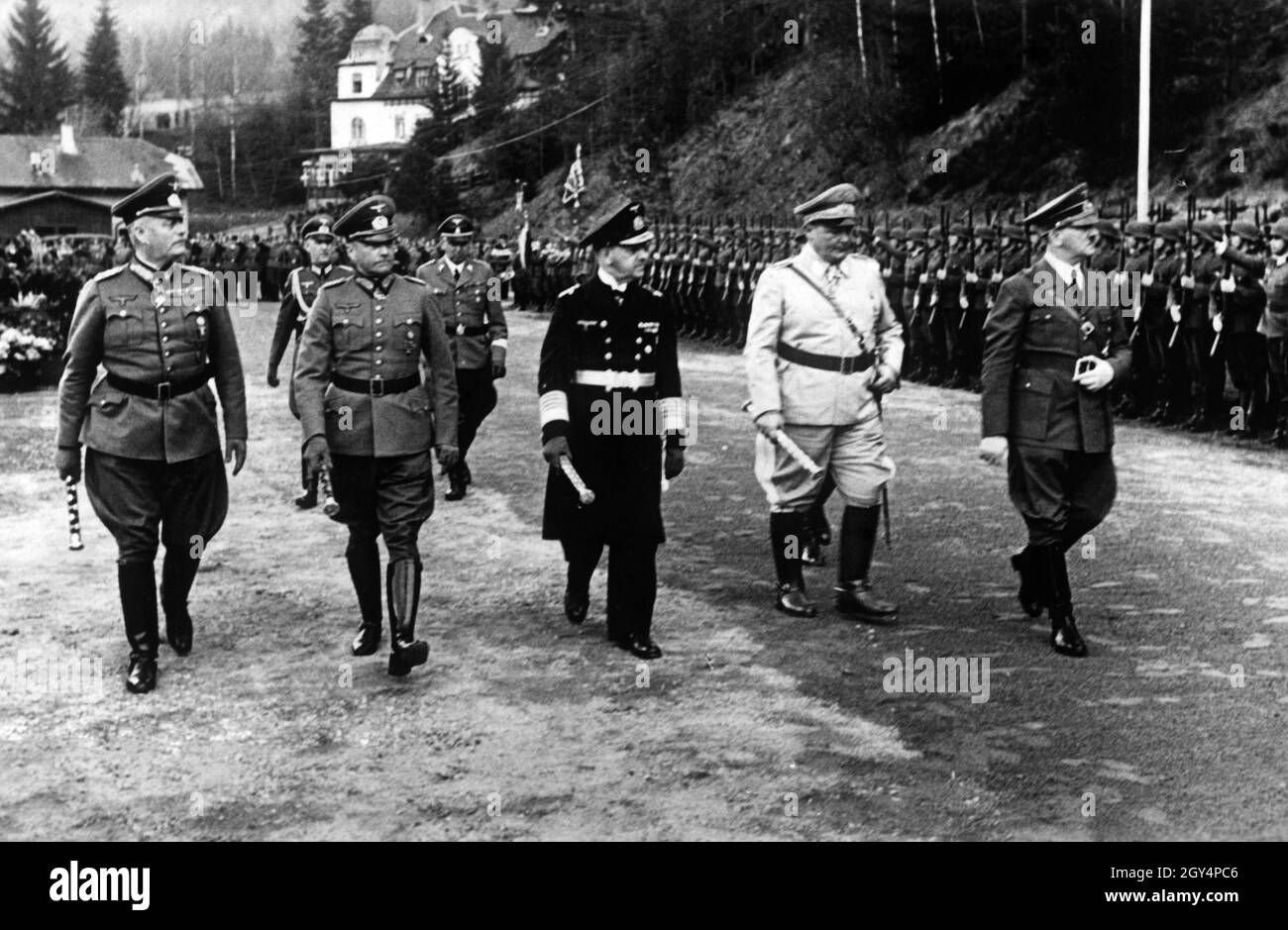From left to right: Wilhelm Keitel, Walther von Brauchitsch, Erich Raeder, Hermann Göring, Adolf Hitler and in the back Rudolf Schmundt and Julius Schaub walk down a front of soldiers of the Wehrmacht who have lined up to honour Hitler. [automated translation] Stock Photo