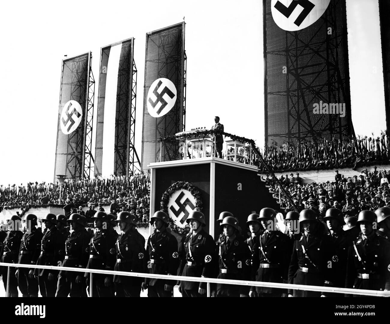 Hitler gives a speech at the festive event on the Tempelhofer Feld in Berlin. In front of him, as always, the Leibstandarte Adolf Hitler had marched up to guarantee the cordon. [automated translation] Stock Photo