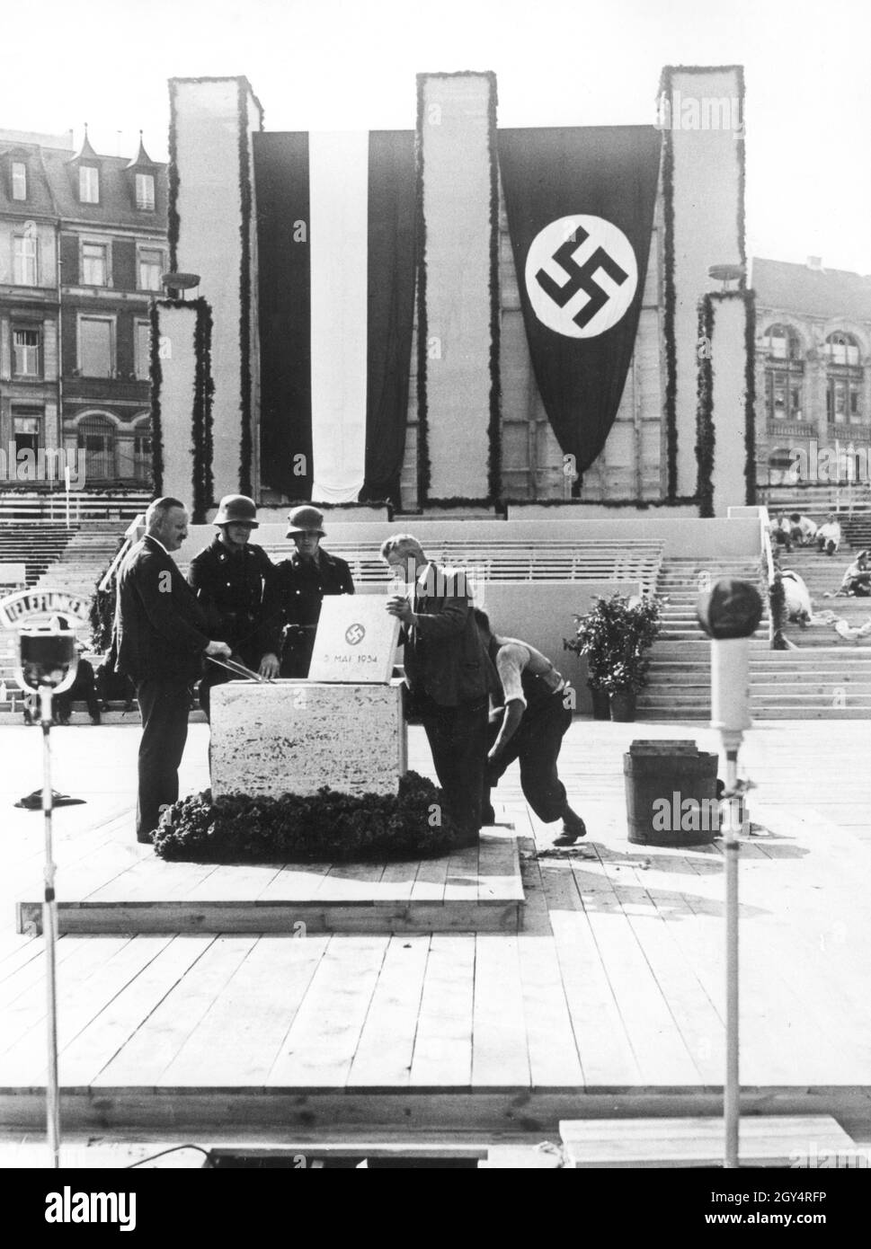 'On May 5, 1934, the foundation stone was laid for the house on Werderscher Markt in Berlin-Mitte, which served as an extension to the Reichsbank. In the morning, a few men, including two members of the ''Leibstandarte SS Adolf Hitler'', made the final preparations before the ceremonial laying of the foundation stone was to take place in the afternoon with Adolf Hitler, Hjalmar Schacht and other Nazi celebrities in front of 6000 people. [automated translation]' Stock Photo