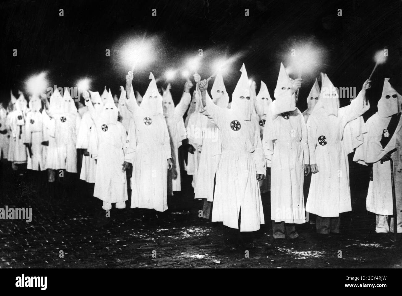 In an effort to intimidate African-American voters ahead of the next local election, members of the Ku Klux Klan are marching through St. Petersburg in the US state of Florida at night carrying torches. [automated translation] Stock Photo