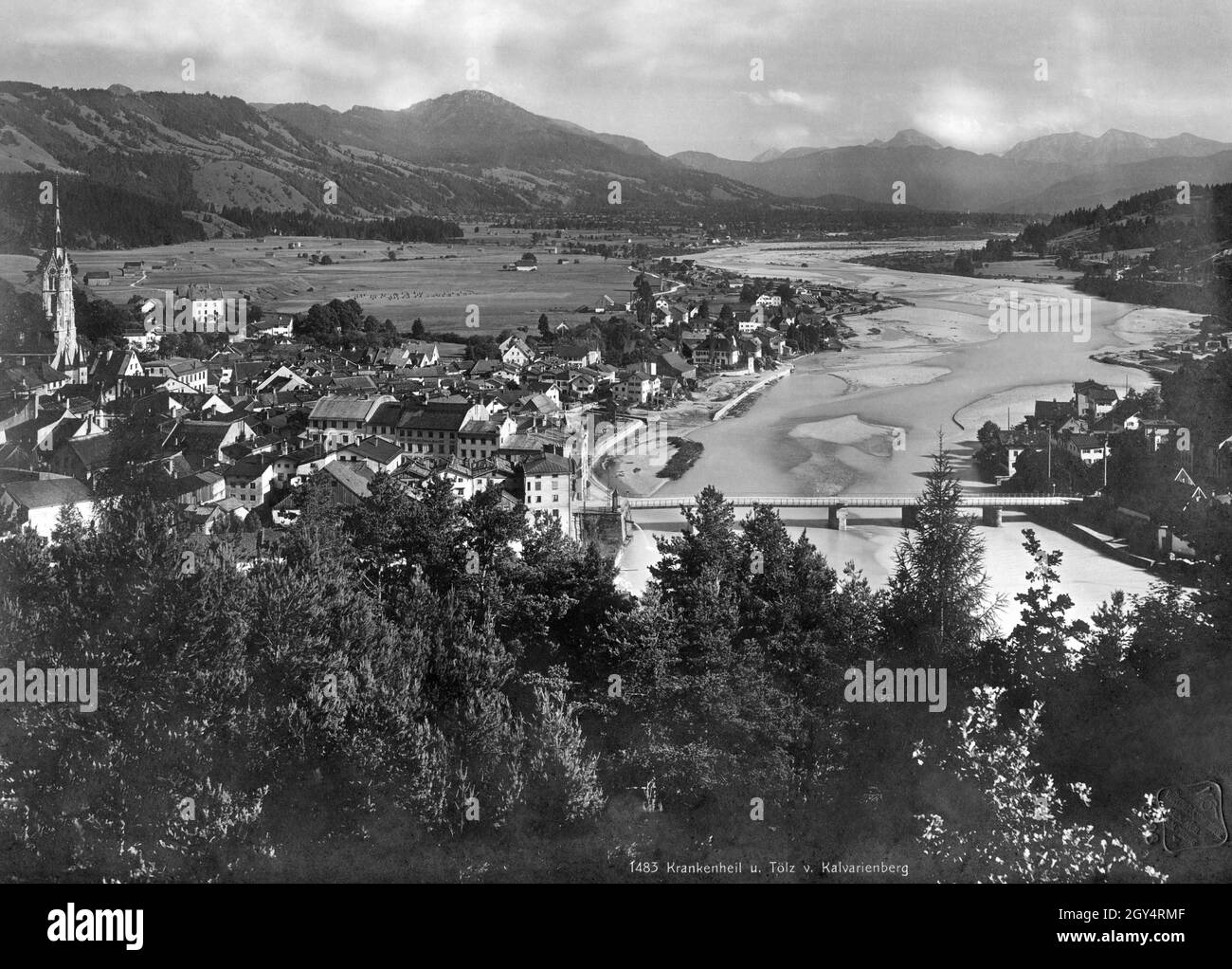 'View from the Kalvarienberg to Bad Tölz, the Isar and the Isarwinkel. On the left you can see the church tower of Mariä Himmelfahrt. The mountain peaks in the background (from left to right): Geierstein, Juifen, Demeljoch, Dürrnbergjoch, Dürrnberg. The photograph was taken by the photo studio ''Würthle und Sohn Nachf. Ges.m.b.H.'' in Salzburg. The undated photo must have been taken before the renovation of the Marienstift (center of the photo, at the Isar bridge) in 1905, probably around 1900. [automated translation]' Stock Photo