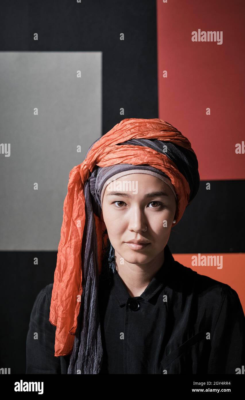 Close-up of young elegant woman in hijab looking at camera Stock Photo