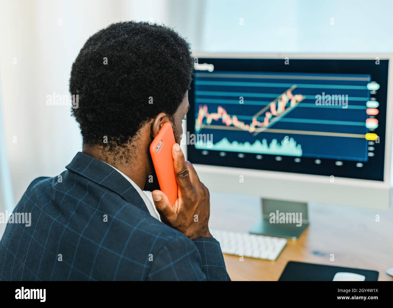 Black male trader talking on smartphone Stock Photo