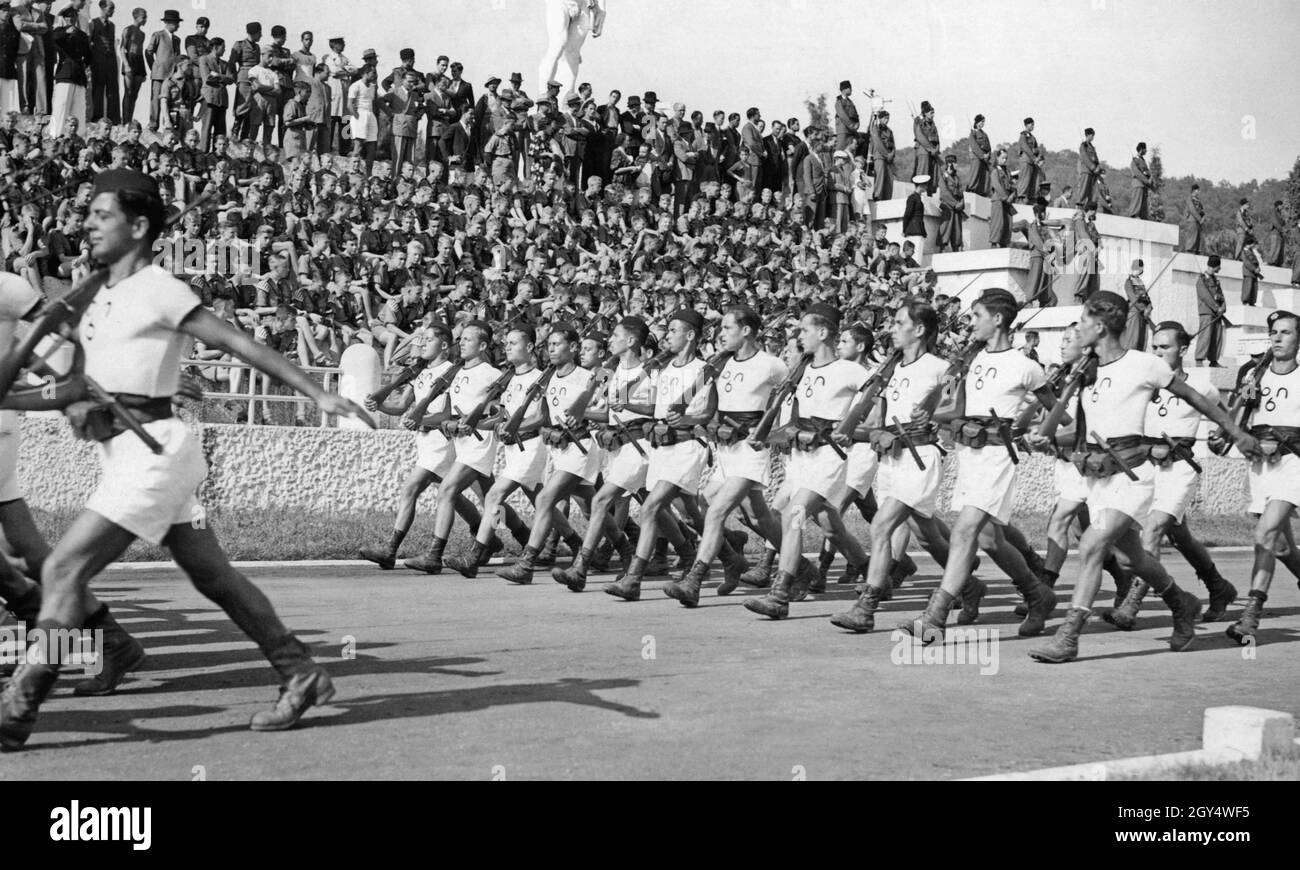 In September 1936, 450 Hitler Youth traveled to Italy. On September 22, they visited the Foro Mussolini (now Foro Italico) in Rome. In the Marble Stadium, they watched a parade of Italian Young Fascists from the Opera Nazionale Balilla, who proudly displayed their practiced lockstep. The Balilla boys shouldered rifles and carried daggers and cartridge bags on their belt. [automated translation] Stock Photo
