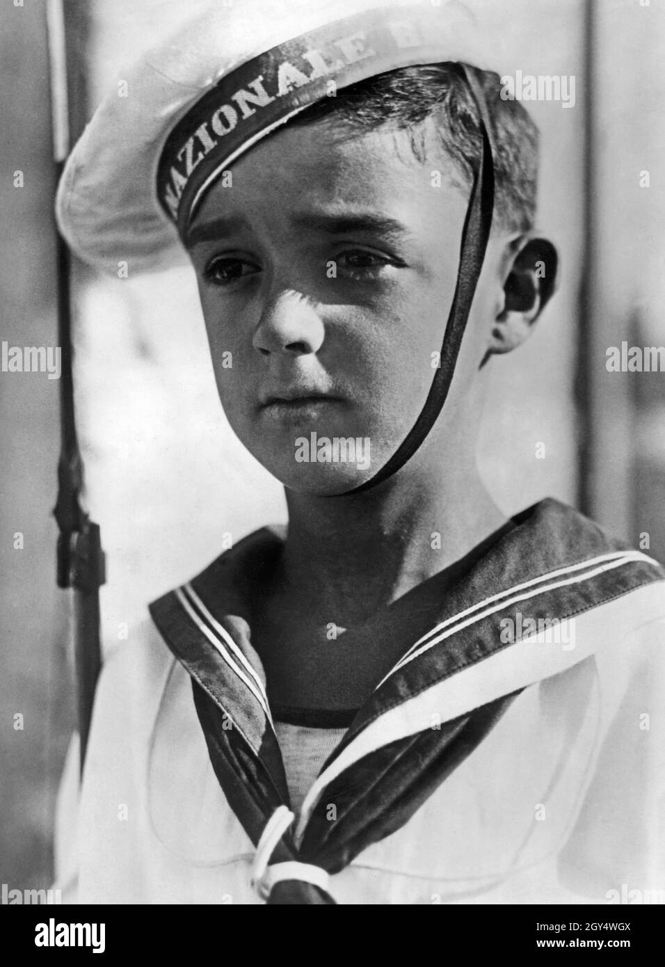This Italian boy is a member of the Marinaretti, the naval training division within the fascist youth organization Opera Nazionale Balilla. The photograph from 1943 shows him wearing a plate cap and sailor suit. [automated translation] Stock Photo
