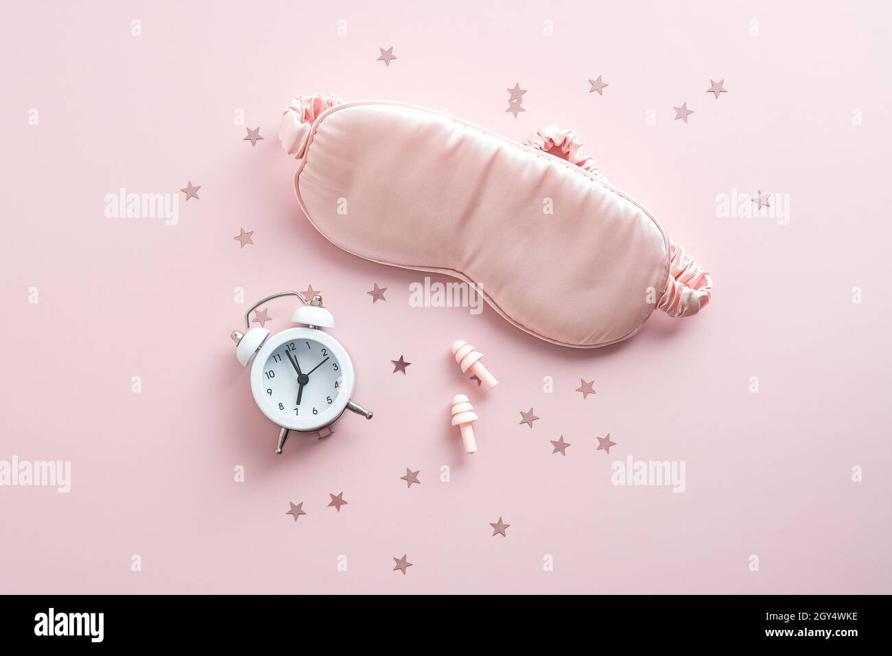 Insomnia treatment concept. Flat lay alarm clock, sleep eye mask