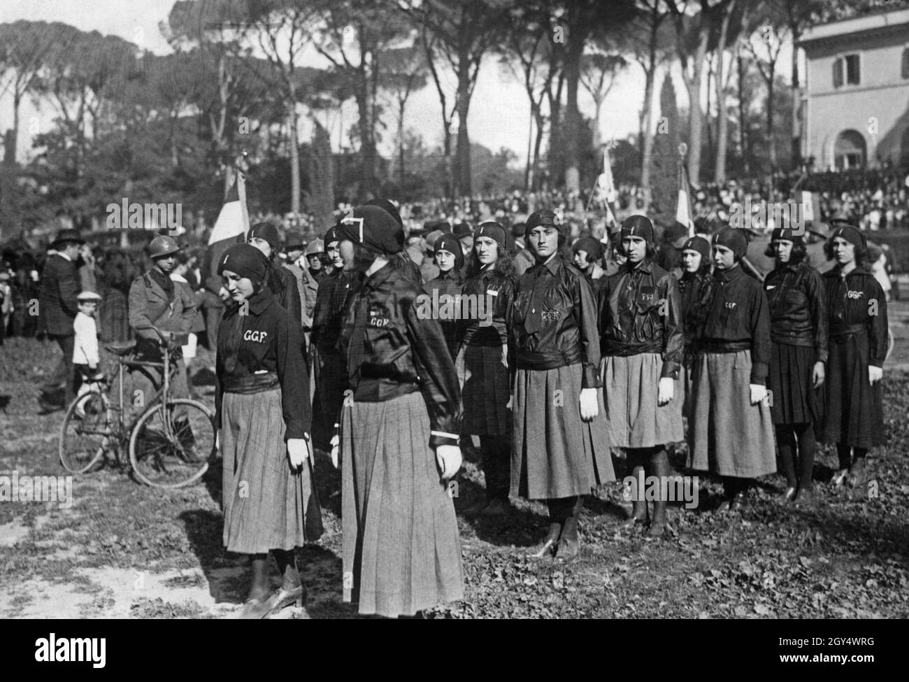 'On April 15, 1923, the Italian Fascists, who had been in power for only a few months, gathered for a large rally in the Piazza di Siena in the Villa Borghese Park in Rome, with their ''Duce'' Mussolini present. The picture shows a group of women on the sports field. By wearing black shirts (so-called black shirts) they express their sympathy for the fascist ideology. In the background on the right is the Casino dell'orologio. [automated translation]' Stock Photo