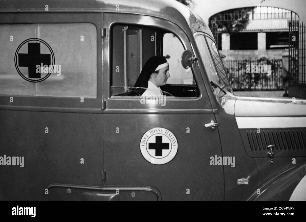 This woman is driving an ambulance of the Italian Red Cross. The photograph was taken in 1940. [automated translation] Stock Photo
