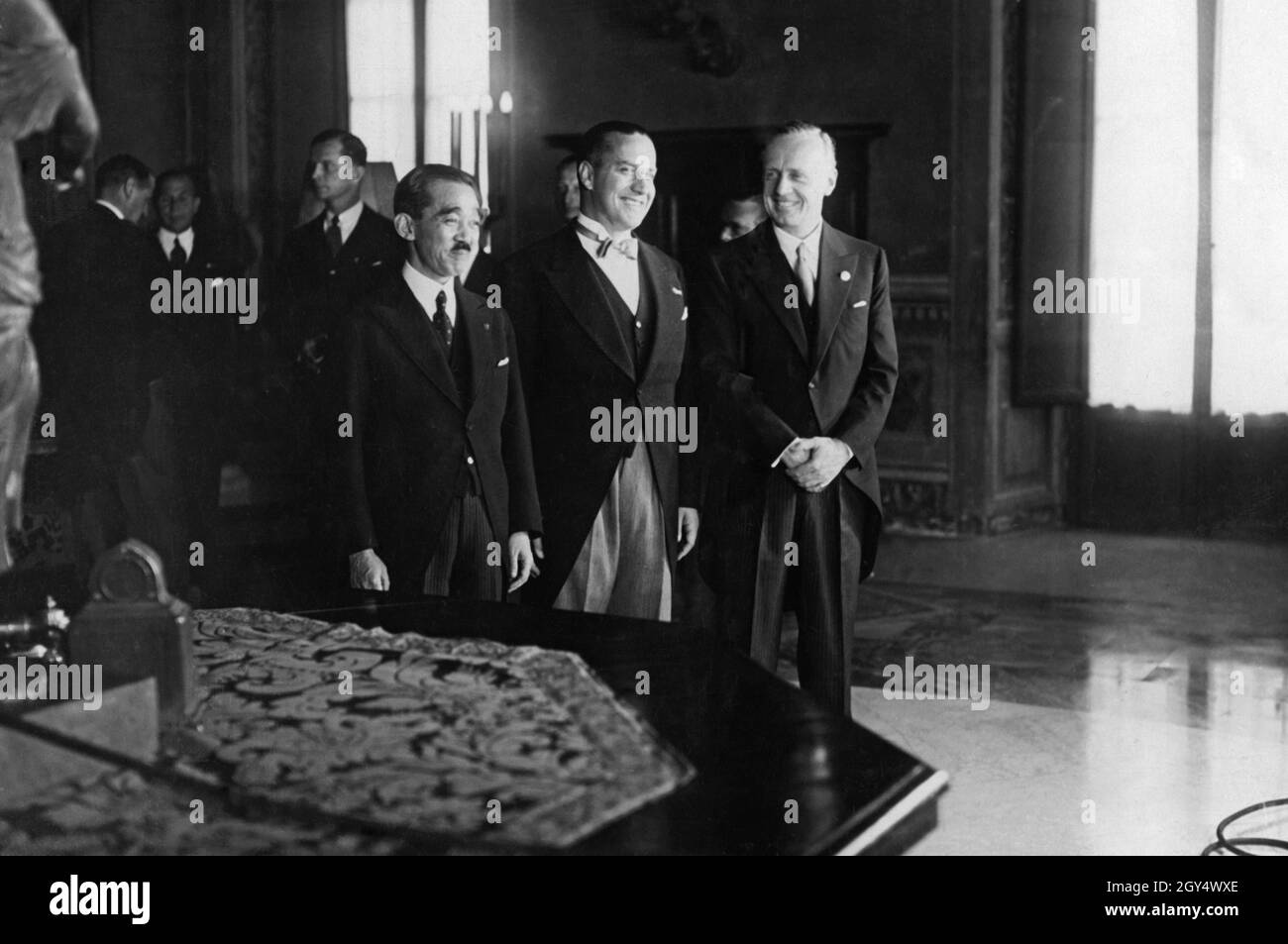 On November 6, 1937, Fascist Italy joined the Anti-Comintern Pact that Germany and Japan had signed the year before. On the morning of November 6, diplomats gathered for the signing of the accession in Palazzo Chigi (then the seat of the Italian Foreign Ministry) in the center of Rome (from left to right): Hotta Masaaki, Japan's ambassador to Italy, Count Gian Galeazzo Ciano, Italian foreign minister, and Joachim von Ribbentrop, then German ambassador in London, here in the capacity of ambassador extraordinary and plenipotentiary for Germany. [automated translation] Stock Photo