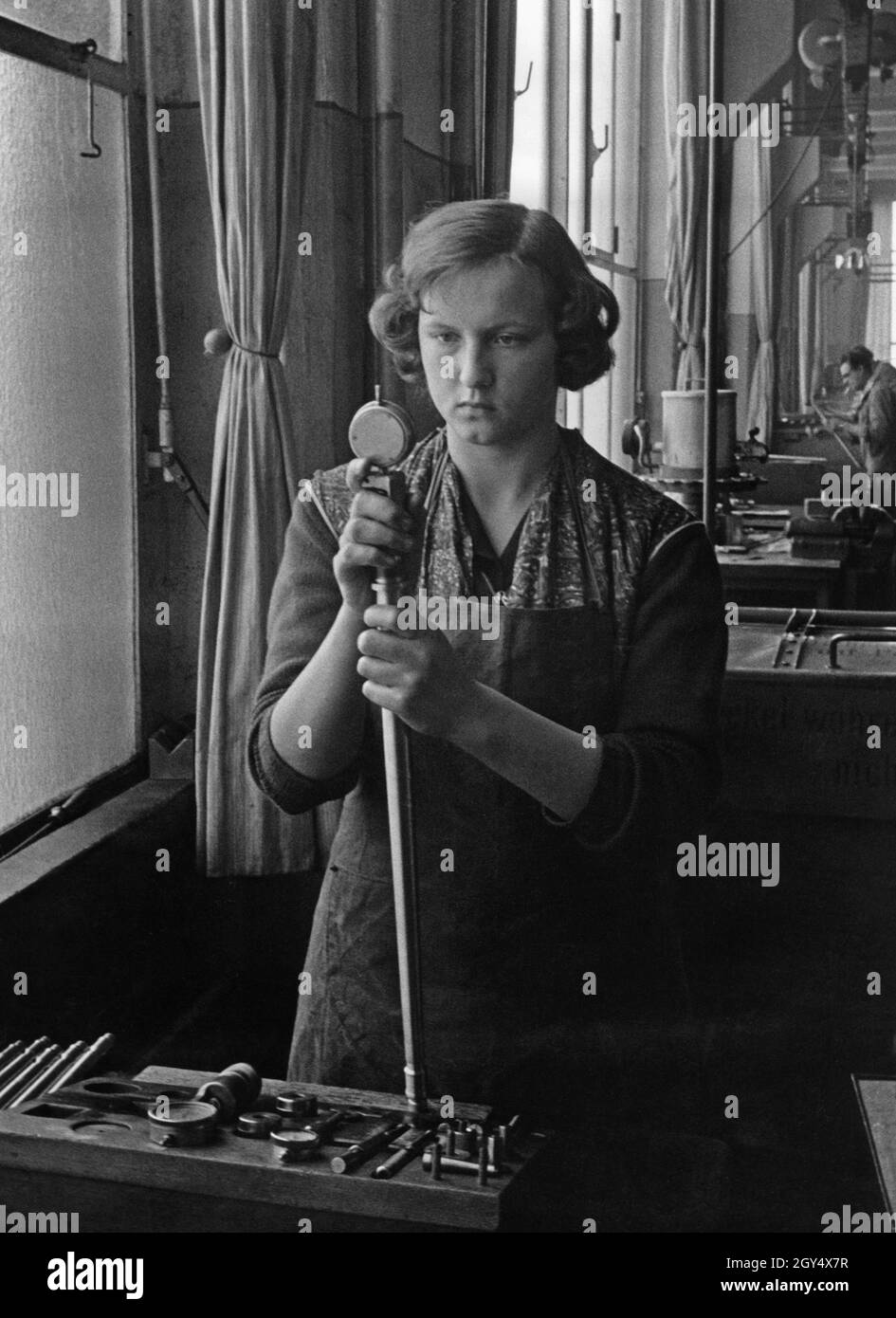 A worker at Rheinmetall AG in Düsseldorf making light infantry weapons ...