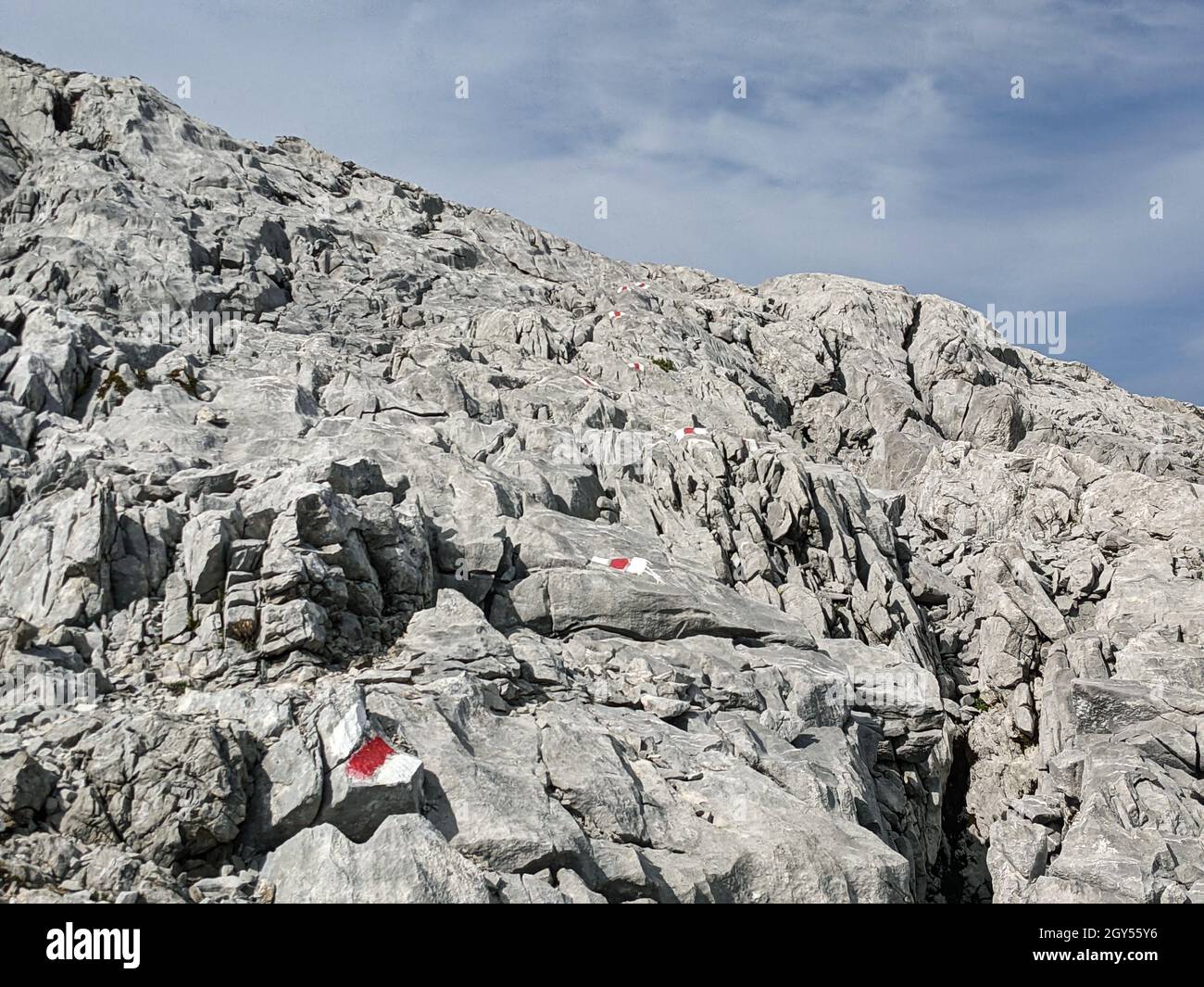 hiking trail over the rocks on the Silberen mountain in the canton of uri in switzerland, Trail signs painted on rock,  Stock Photo