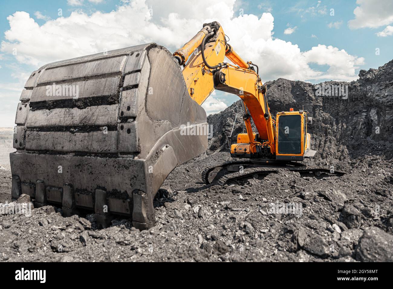 Large quarry dump truck. Big yellow mining truck at work site. Loading ...