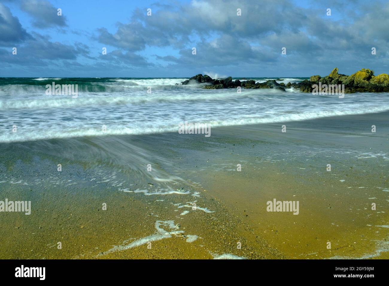 The retreating tide at Rhosneigr beach on Anglesey, North Wales, UK Stock Photo