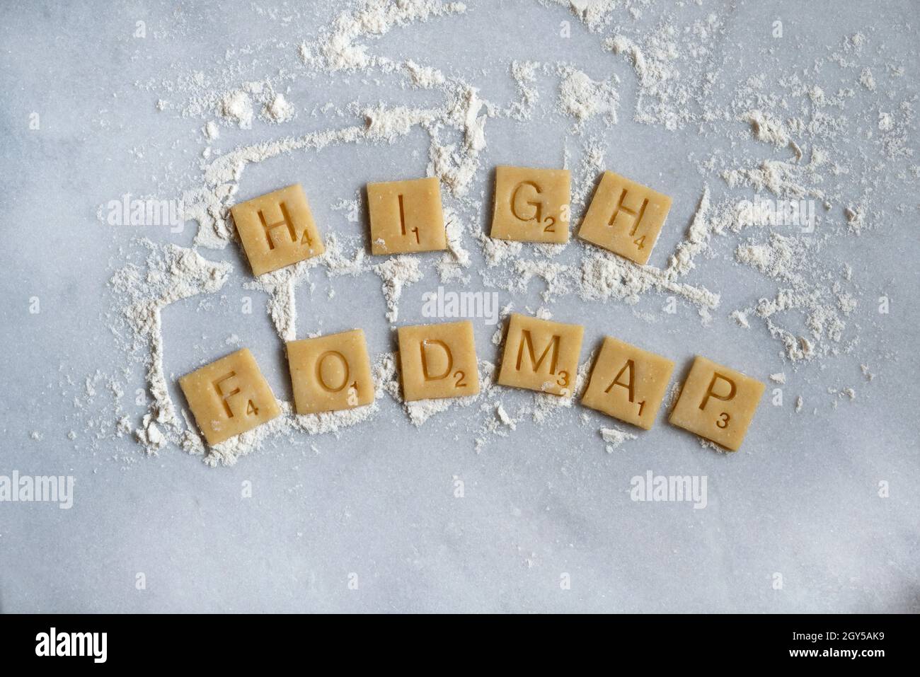 Wheat pastry squares spelling out 'High Fodmap'. Stock Photo